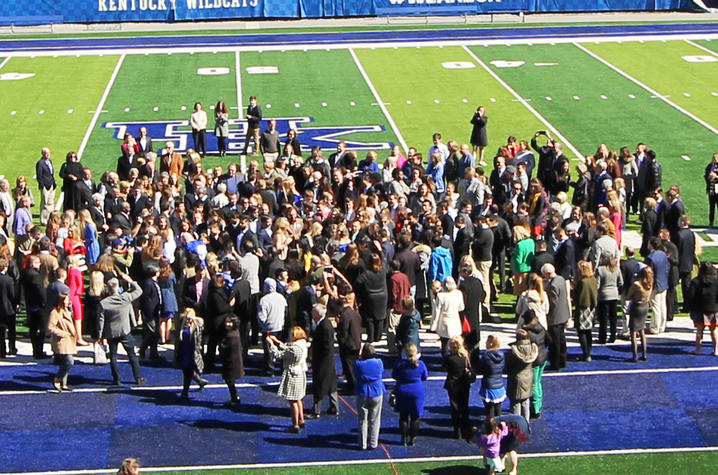 UK COM Students Standing on Kroger Field