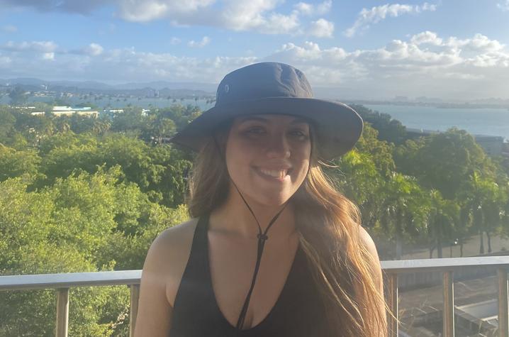 Kaitlyn Johnson in hat with green landscape behind her