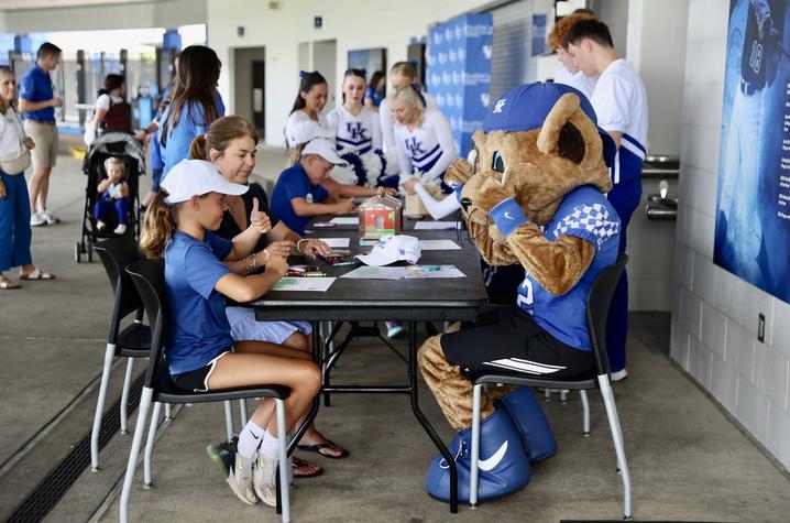Image of children sitting at table with costumed mascot
