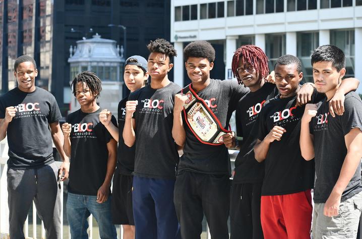 Photo of Jamyle Cannon with students from The Bloc