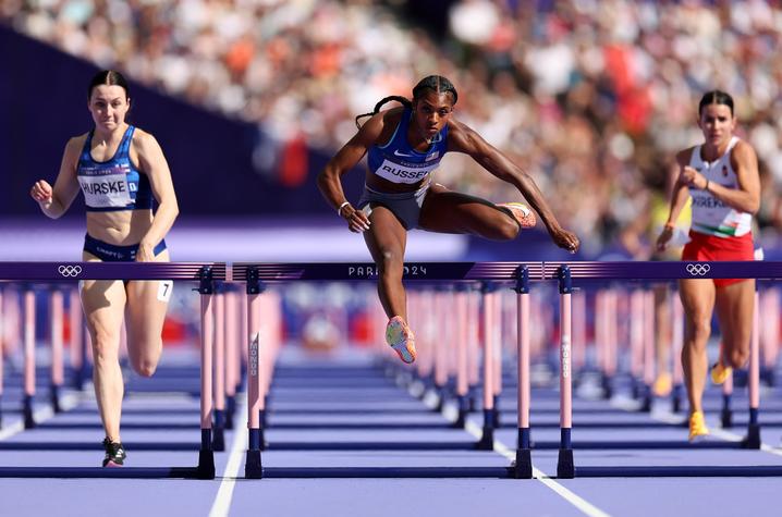 Masai Russell (center) takes home the gold for Team USA in the 100-meter hurdles. Photo by Getty Images.