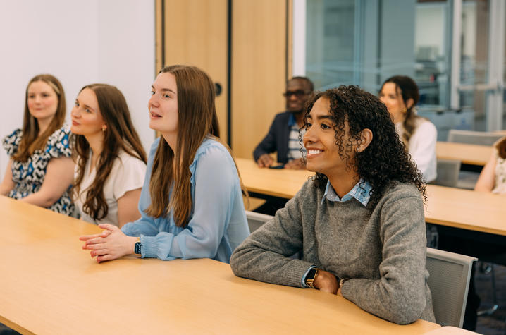 A group of students sit at desks in a classroom