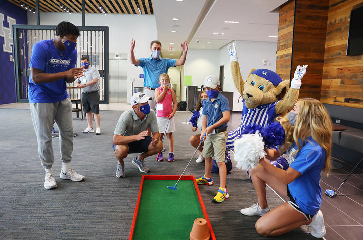 photo of child golf on miniature course