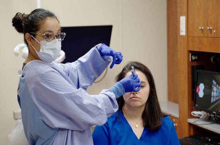 Marcia demonstrating a procedure on a student
