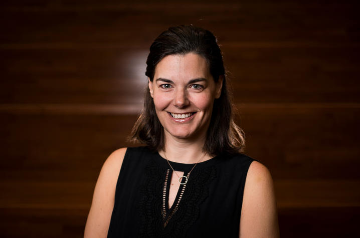 Staff photo of Alison Davis wearing black on wooden background