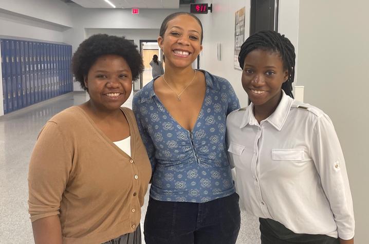 three young women in school hallway