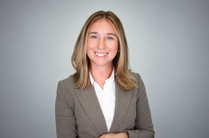photo of Amanda Duncan A smiling woman with shoulder-length blonde hair wears a gray blazer and white shirt against a soft gray background.
