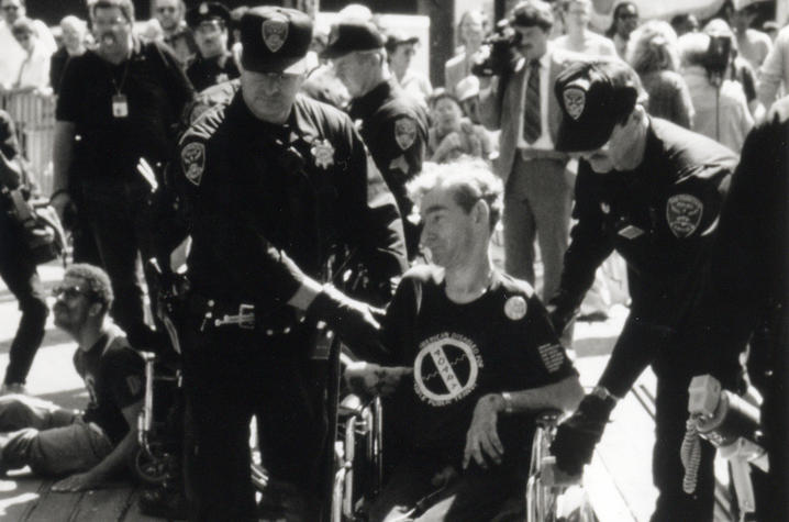 Police lead Campbell away from a disability rights demonstration. Campbell said he’s been arrested nearly 30 times while protesting. Photo by Tom Olin and courtesy of American Documentary Inc.