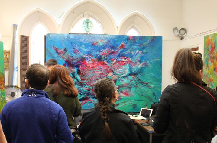 Photo of surgical residents viewing a painting