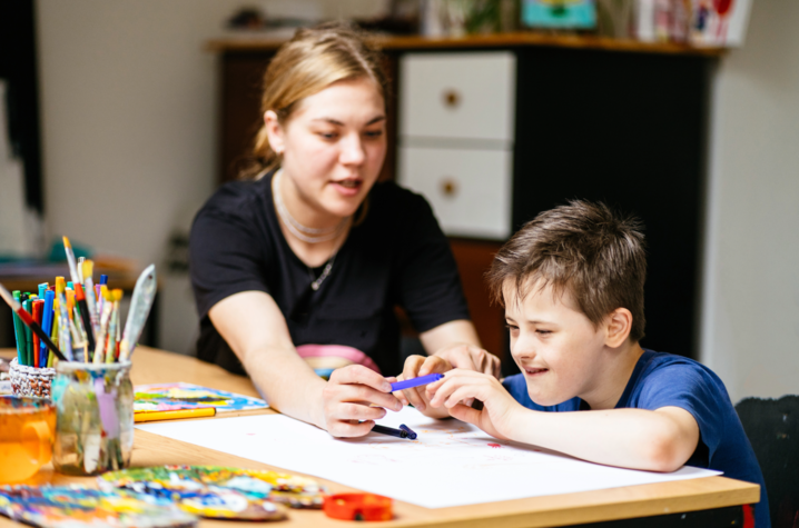 A student and a teacher working together on a project. 