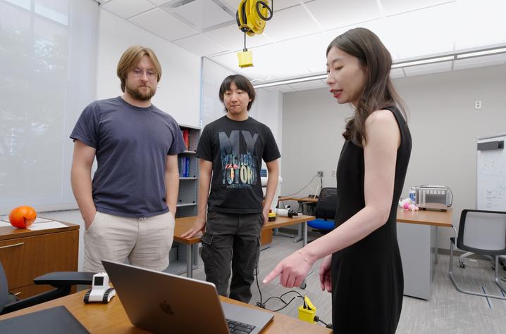 Biyun Xie stands on the far right. She's with students in her robotics lab