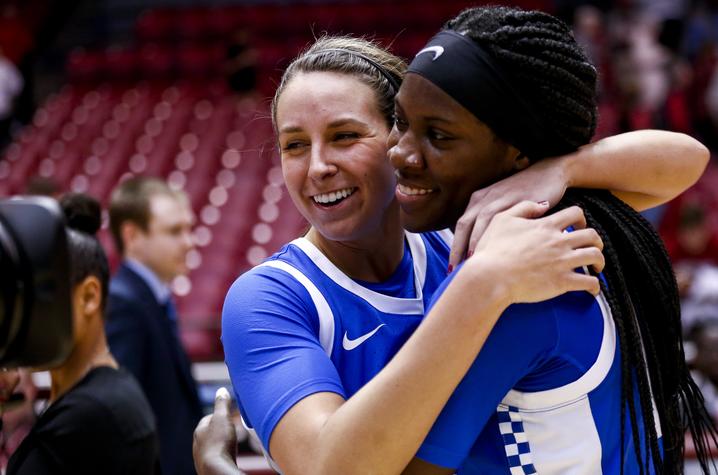 blair and rhyne hugging on the basketball court