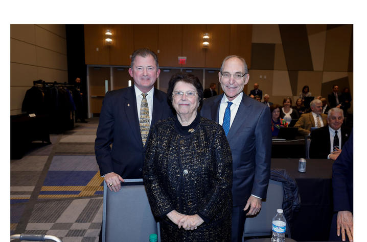 photo of UK Board of Trustees Chair Britt Brockman, philanthropist Mira Ball, and President Eli Capilouto following the board's acceptance of Ball's $10 million gift.  