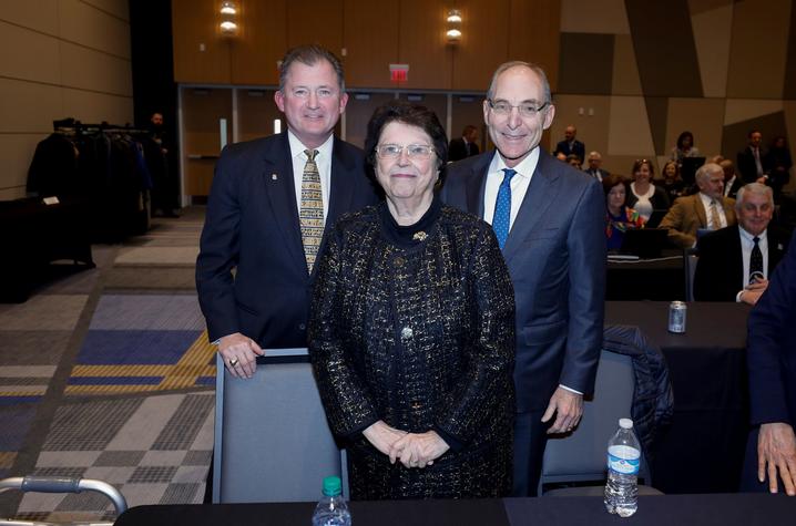 photo of UK Board of Trustees Chair Britt Brockman, philanthropist Mira Ball, and President Eli Capilouto following the board's acceptance of Ball's $10 million gift.  