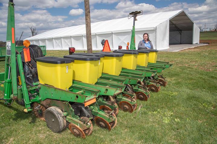 UK Research and Education Center director Carrie Knott stands by a corn planter and a  newly constructed storage structure. Photo by Stephen Patton