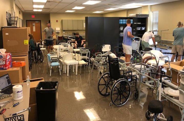 Students work to clean and assess donated medical equipment. The equipment is then refurbished and given to those in need. Photo provided.