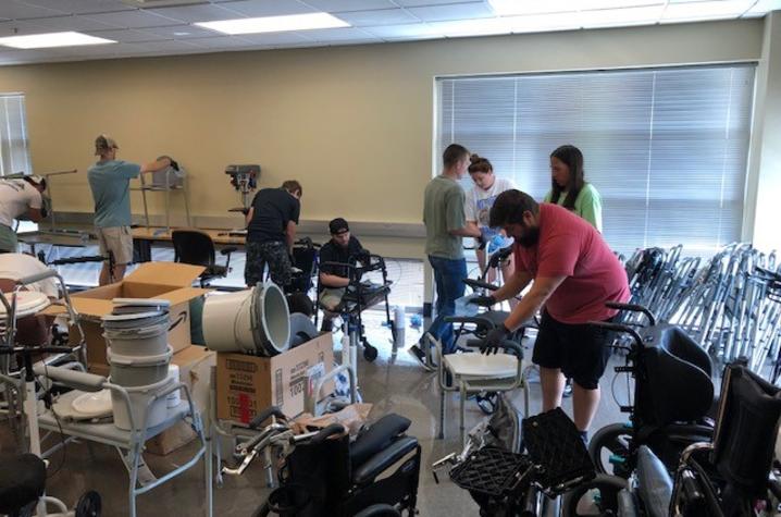 Students work to clean and assess donated medical equipment. The equipment is then refurbished and given to those in need. Photo provided.