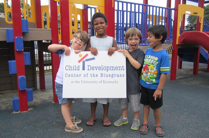 photo of kids holding Child Development Center of the Bluegrass sign