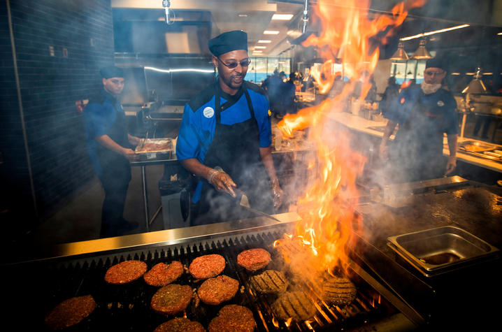 photo of chef grilling hamburgers in Champions Kitchen