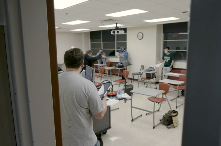 photo of masked acoUstiKats members spaced out in classroom for a rehearsal