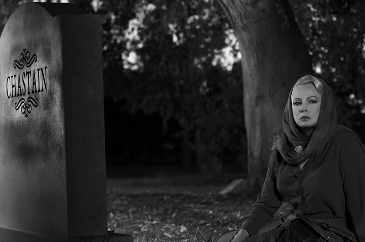 black and white photo of still from "Cemetery Tales" of actress at tombstone