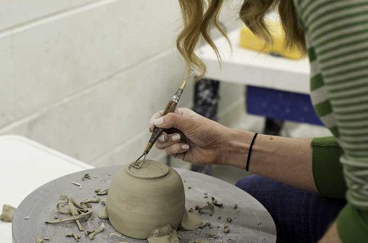 photo of student working in Fine Arts Institute ceramics class