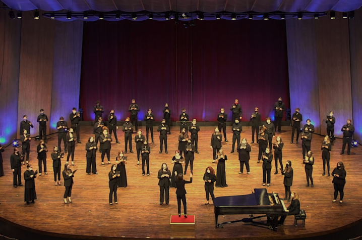 Photo of UK Choristers physically distanced on Singletary Center stage performing for virtual "Collage"