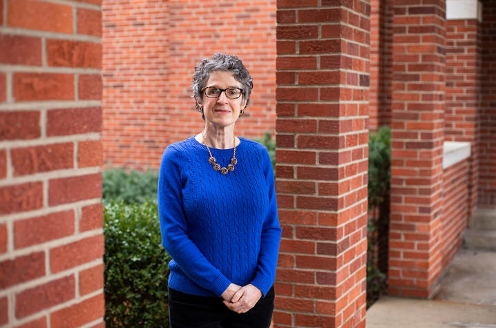 Christine Schraff outside Mandrell Hall in blue sweater