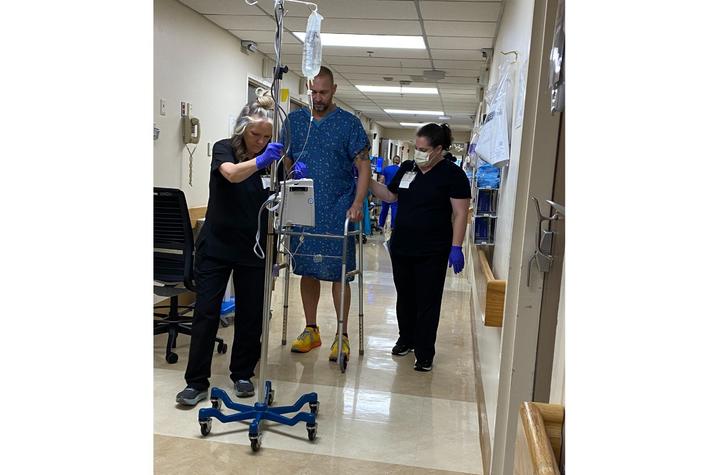 Schmidt taking his first steps after his hip replacement surgery at UK HealthCare. Photo provided by Chris Schmidt.