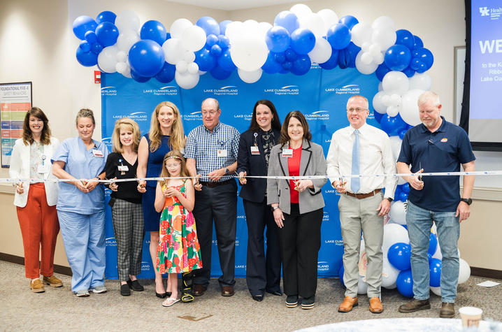 Image of group of people cutting a ribbon