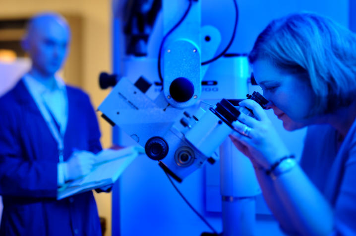 Photo of Donna Wilcock, Sanders-Brown Center on Aging, at her microscope