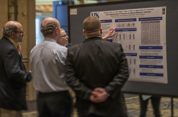 Photo of poster presentation at Cardiovascular Research Day conference