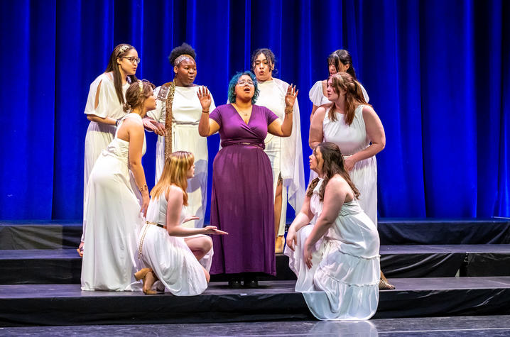 Eight singers surrounding a soloist on stage