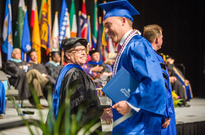 photo of Dean Cox and student at commencement ceremony