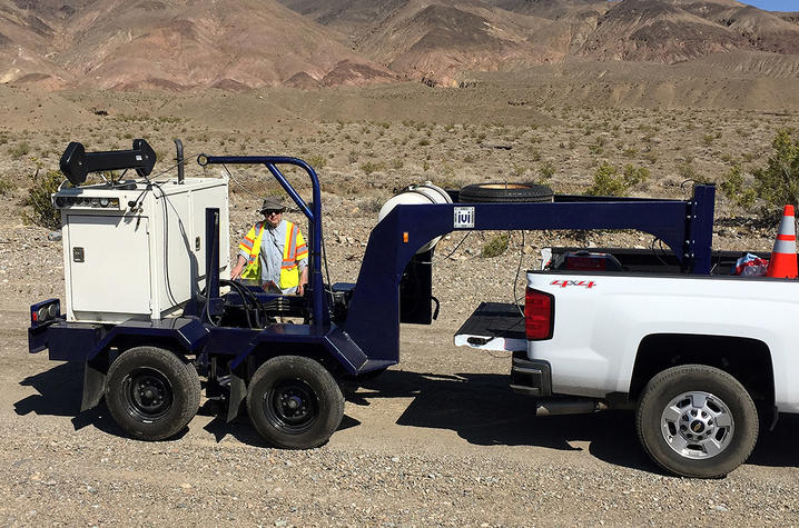 photo of Ed Woolery with active vibratory seismic energy source in Death Valley