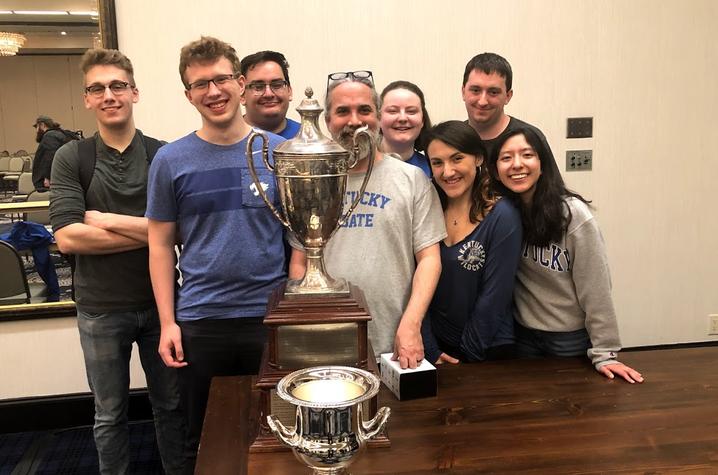 photo of 2019 UK Debate team with trophy