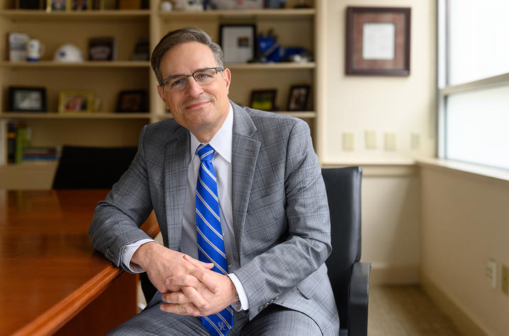 Photo of Bob DiPaola sitting at a desk in an office