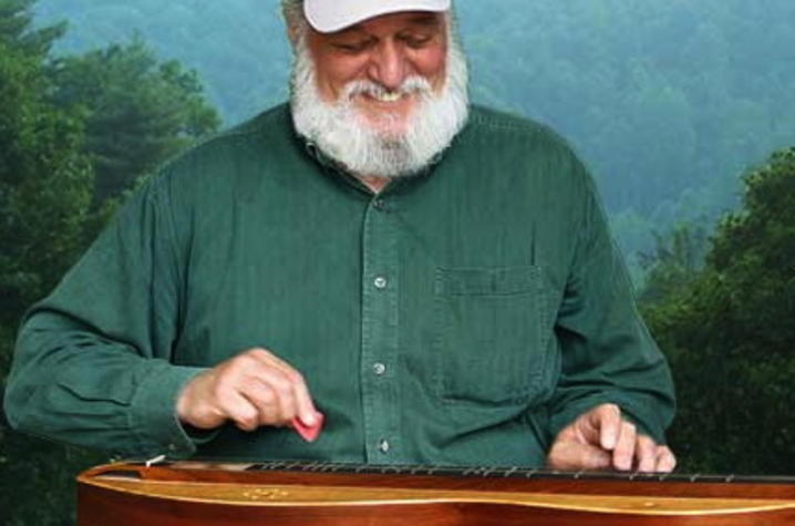 photo of Don Pedi playing dulcimer with mountain view behind