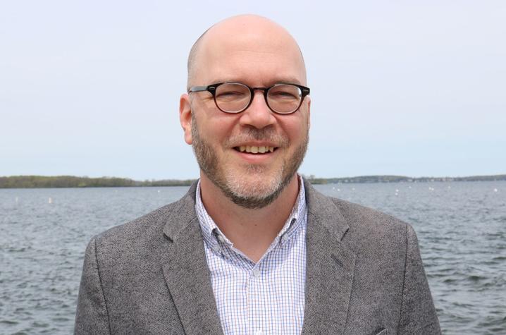 headshot photo of Doug Way in front of body of water