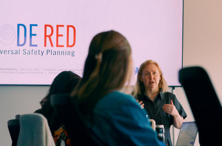 Person presents CODE RED Universal Safety Planning training to a group seated in a conference room. Person presents CODE RED Universal Safety Planning training to a group seated in a conference room.
