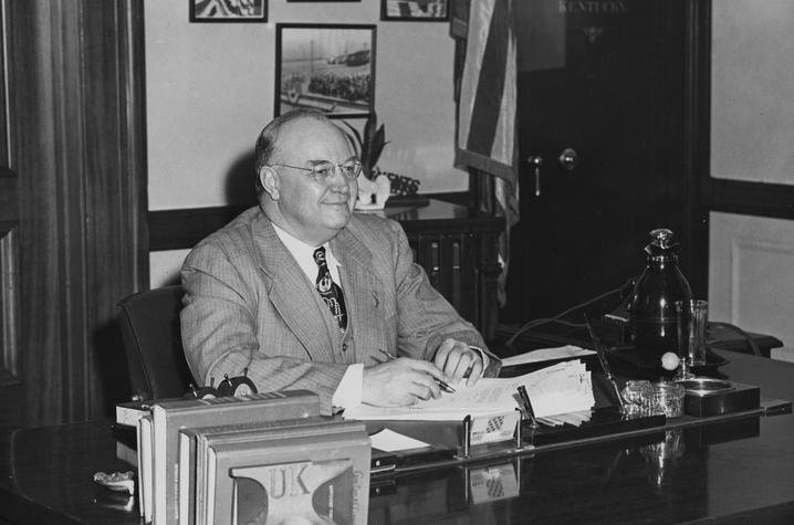 black and white photo of Governor Earle C. Clements seated at desk