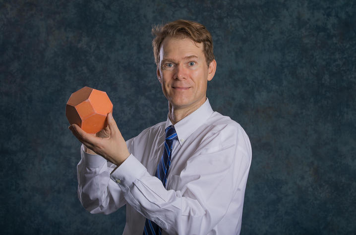 photo of Richard Ehrenborg with a polyhedron