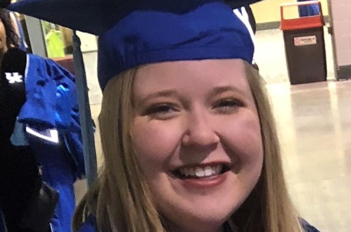 headshot photo of Emily Stoker in cap and gown