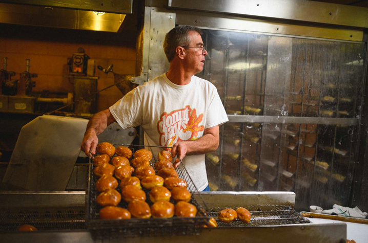 As the owner of Donut Days Bakery, Fred Wohlstein spends his days surrounded by delicious—and tempting—baked goods. (Photo was taken before COVID-19)