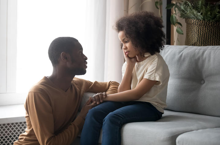 Photo of father talking to daughter