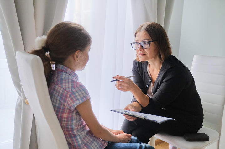 Photo of woman counseling young girl