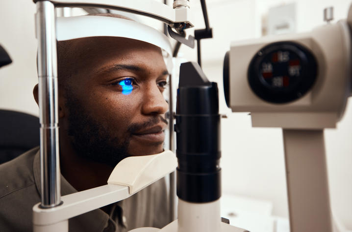 photo of man receiving eye test with machine