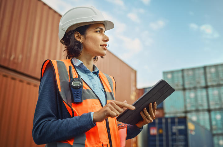 female construction worker with tablet outdoors