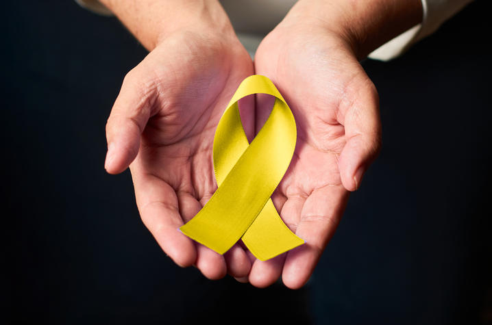 Photo of Person Holding Yellow Ribbon