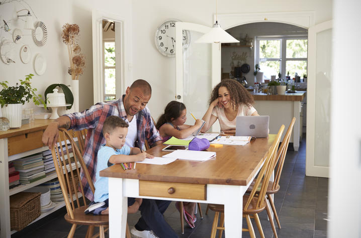 photo of family doing homework at the table